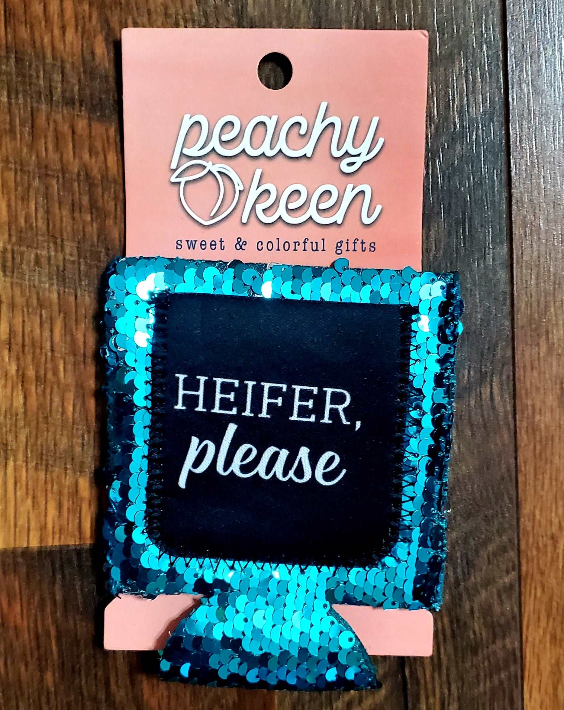 Teal sequin can cooler that says heifer please.