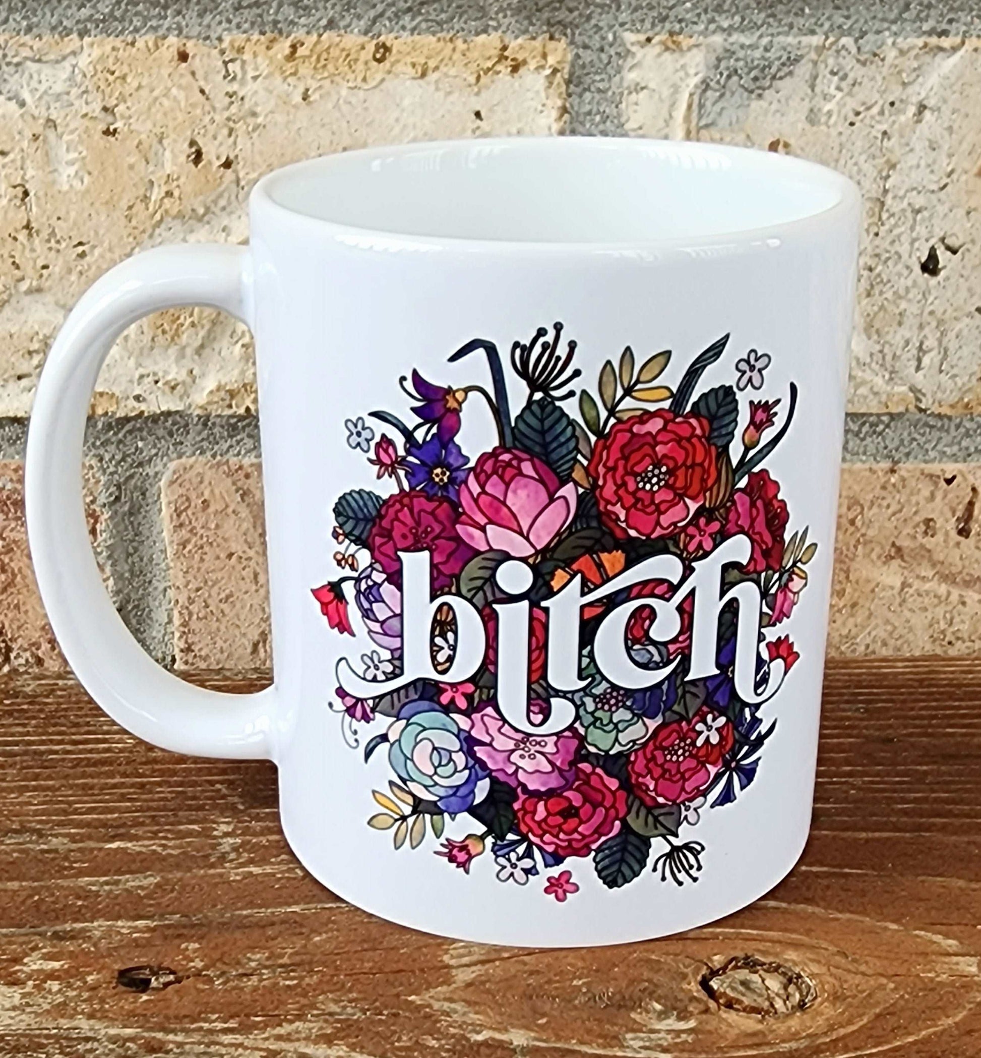 Floral mug with the word bitch on it. 