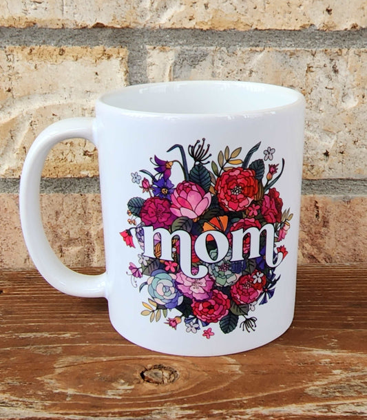 White floral mug with Mom on it. 