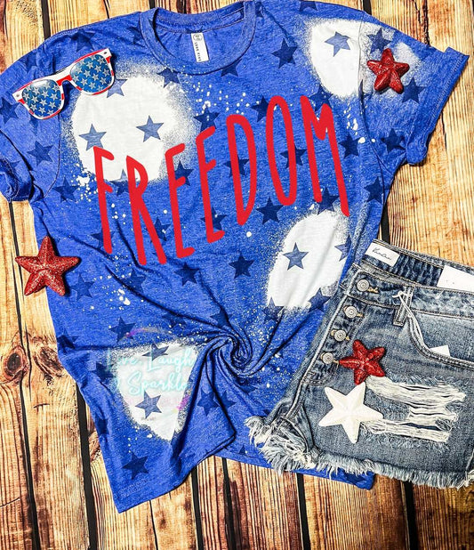 Blue bleached tee with stars on it with the word Freedom in red.