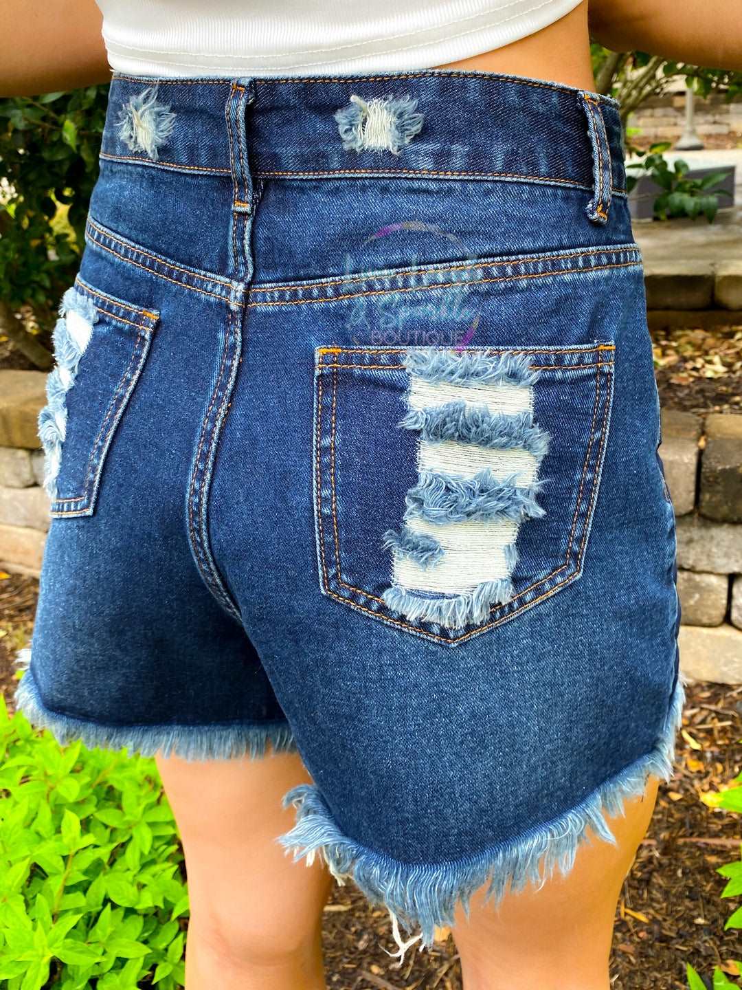Back of shorts have distressed pockets. 