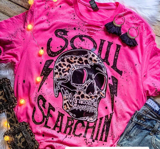 Pink tee with bleach and distressing with words soul searchin and a skull.