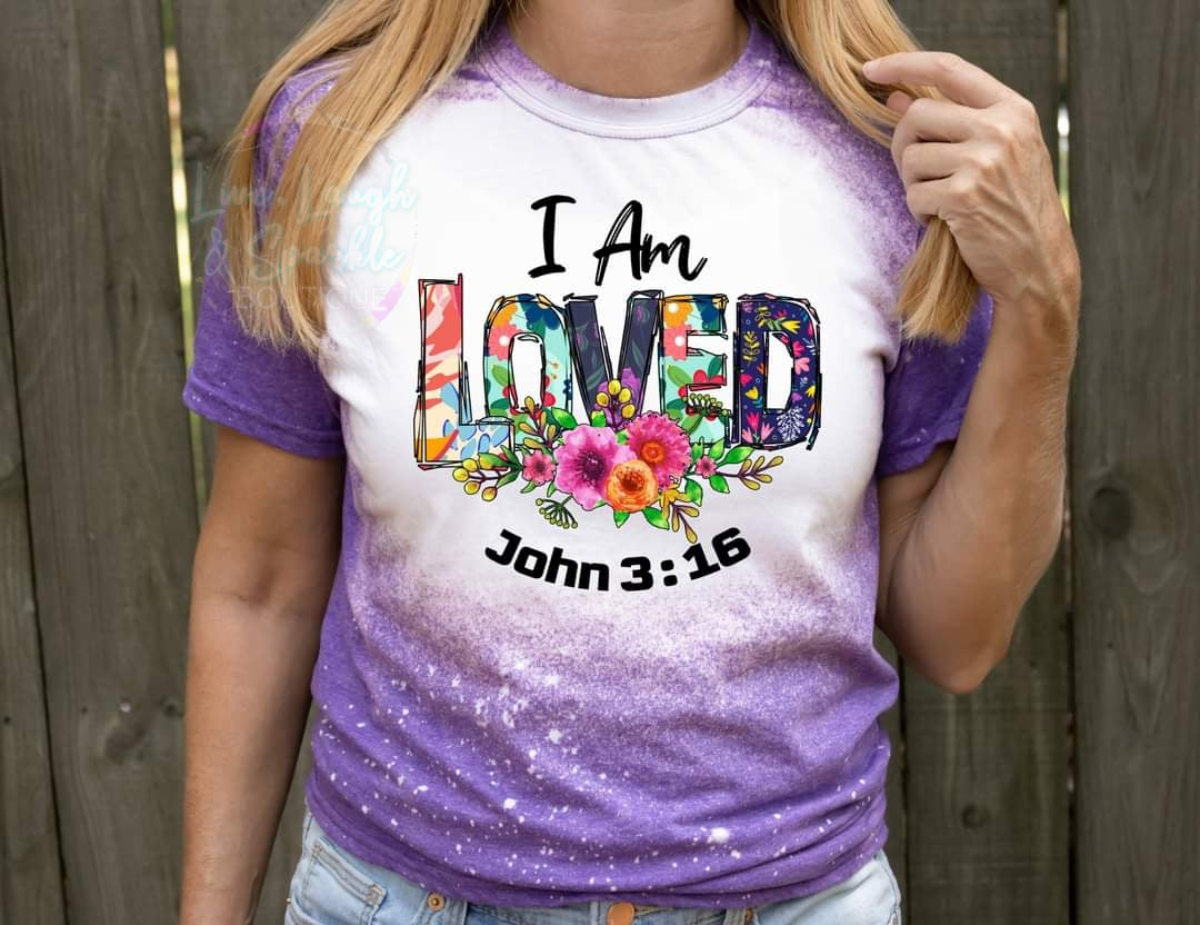 Purple bleached tee with flowers and words that say I am Loved John 3:16.