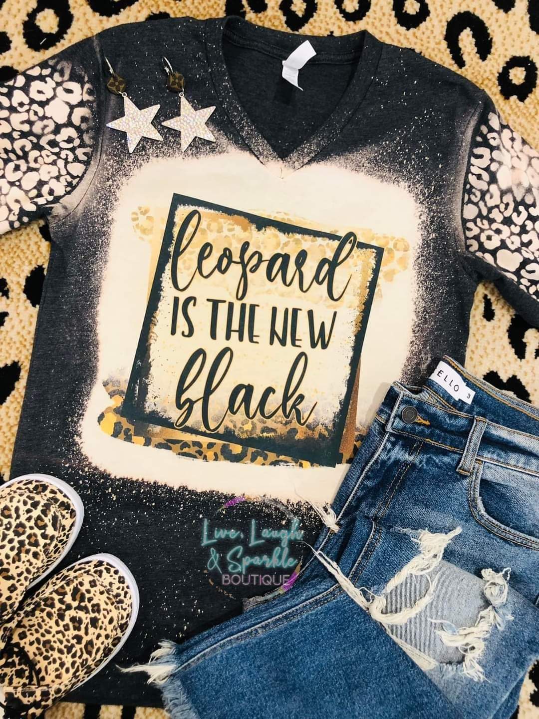 Black bleach tee with leopard print sleeves and words that say leopard is the new black.