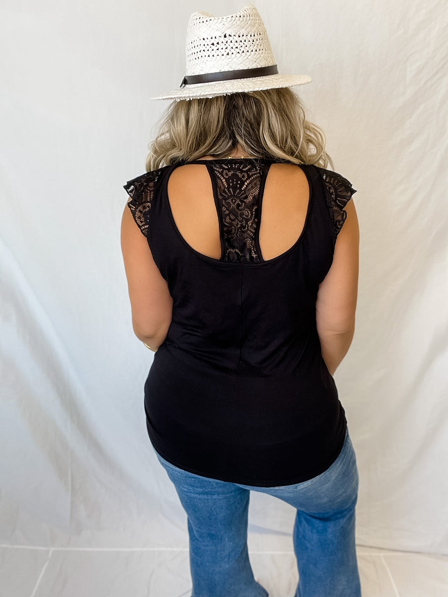 Black top with short lace sleeves & lace backing.