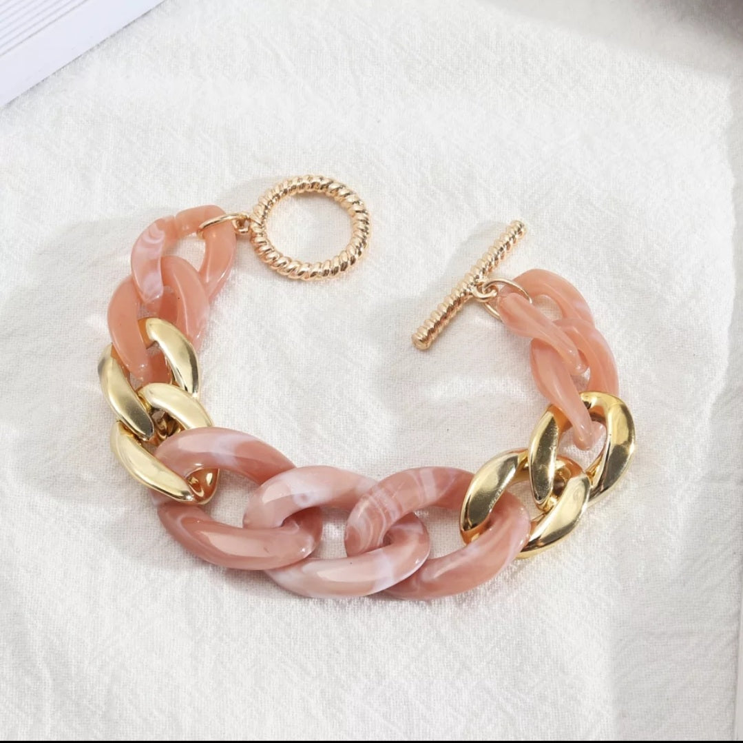 Pink and gold chain link bracelet.